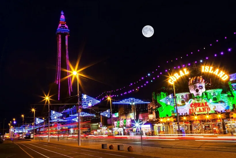 Blackpool Tower and the famous Illuminations lighting up the promenade at night