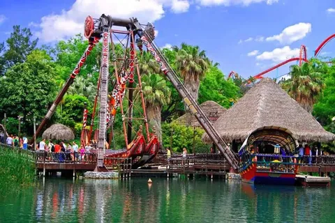 A water ride at the Port Aventura theme park, surrounded by palm trees