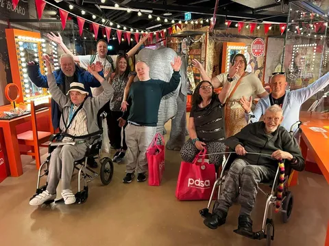 The Spiral group waving together during a shopping trip