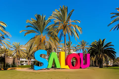 The colourful SALOU letters sign framed by palm trees