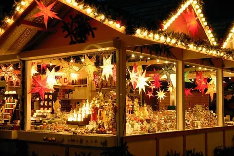 A Christmas market stall lit up with stars and decorations