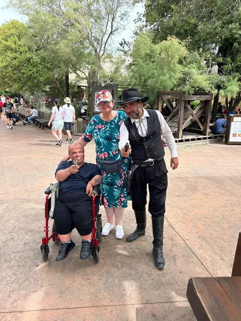A holidaymaker with costumed performers at Port Aventura