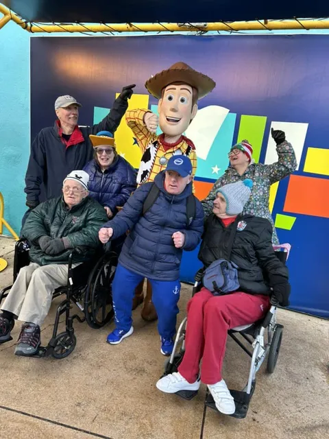 The group posing with Woody from Toy Story