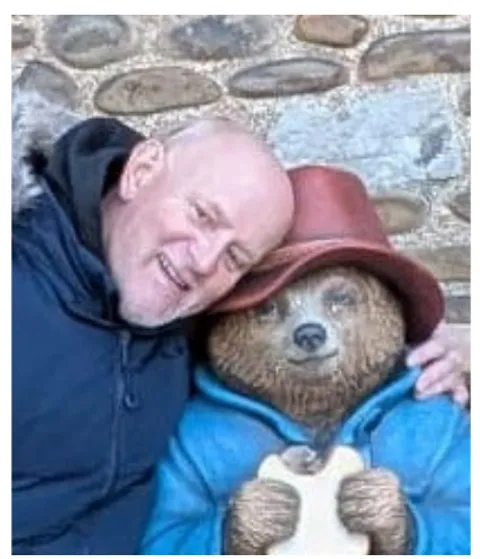 Stephen, our minibus driver, hugging a Paddington Bear statue